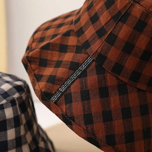Close-up of brown checkered sun hat with high-quality stitching and fabric texture