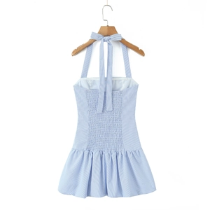 Detail of blue and white striped halter dress featuring a bow tie and smocked waistline