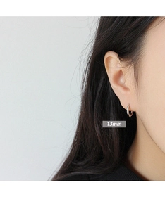 Close-up of 13mm S925 sterling silver hoop earring worn on model for size reference