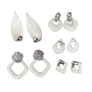 Five pairs of geometric silver earrings with white resin and twisted metal designs