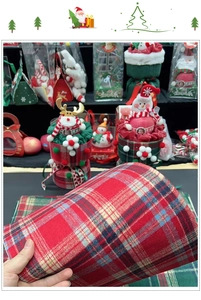 Close-up of red and green plaid fabric material for Christmas gift flower wrapping