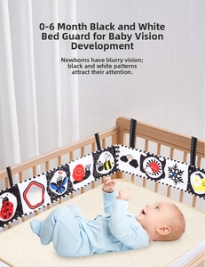 Detail of high-contrast black and white baby cloth book with ladybug and butterfly patterns
