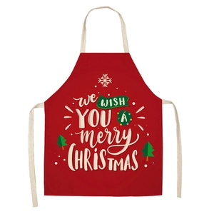 Detail of red Christmas apron with white festive graphics and merry Christmas typography