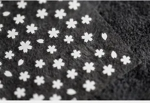 Macro detail of white cherry blossom nail stickers with transparent 5D matte texture