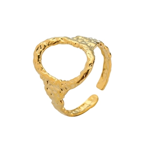 Detail of gold-plated open ring featuring unique hammered texture and hollow irregular shape