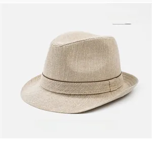 Detailed weave texture of a beige straw trilby hat with dark brown decorative bands