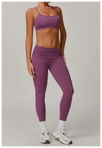 Close-up of high-waisted yoga pants featuring unique gathered fold-over waistband design