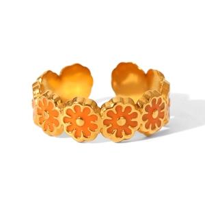 Detail view of gold plated daisy ring featuring orange enamel flower petals and open band