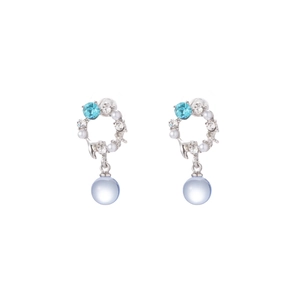 Detail of silver drop earrings featuring sky blue crystals and translucent spherical pendants