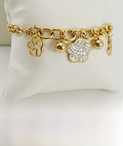 Detail of 18K gold rose flower bracelet with sparkling crystals and hand-set diamonds