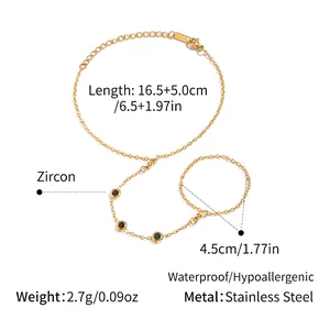 Macro view of gold chain hand harness featuring three green round-cut cubic zirconias
