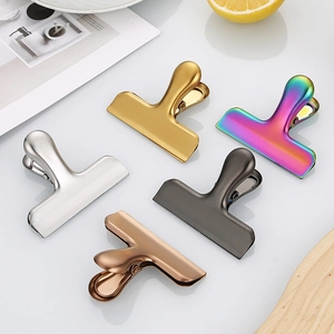Set of five colorful stainless steel food sealing clips in gold, silver, bronze, and black