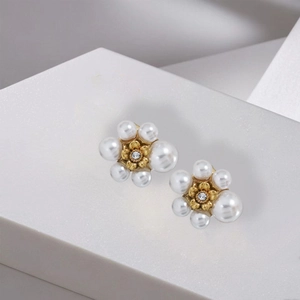 Elegant floral pearl stud earrings with zircon center on minimalist stone base