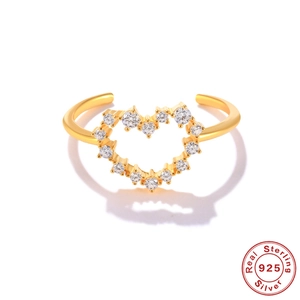 Detail of a 925 sterling silver gold ring featuring a heart-shaped clear gemstone design