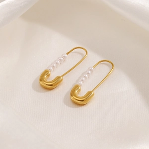 Vintage gold-plated paperclip earrings with five elegant faux pearls on a silk background