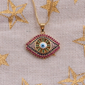 Detail of evil eye pendant with colorful gemstones and enamel on gold necklace