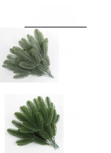 Detail of artificial pine branches with flocked snow vs plain green needle styles