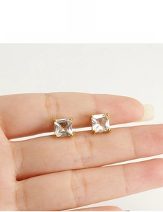 Détail macro de boucles d'oreilles carrées en zircon plaqué or 18 carats sans plomb ni nickel