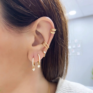 Golden heart drop earrings and zircon ear cuff set worn by model in high-quality detail