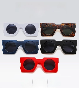 Flat lay of retro square sunglasses in white, tortoiseshell, blue, black, and red colors