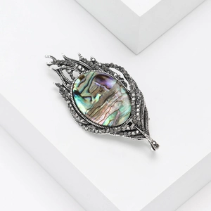 Fashionable leaf brooch with natural abalone shell inlay and small crystals in silver finish