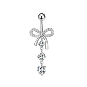 Silver belly button ring featuring a zircon bow and heart pendant on white background