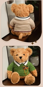 Close-up of teddy bear plush toy wearing a green knit sweater with metal chain detail