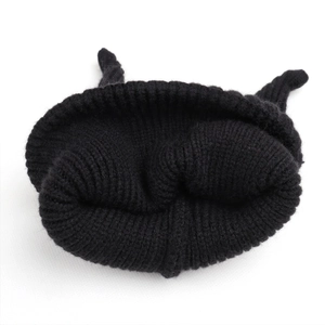 Close-up of black cable knit beanie for kids featuring cute decorative cat ears design