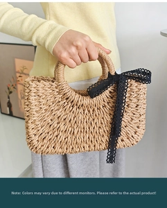 Close-up of hand-woven straw handbag featuring black lace bow details for summer beach vacation