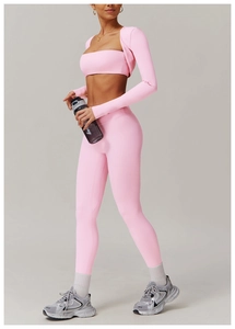 Detail view of pink three-piece yoga set showing brushed texture and high waist leggings
