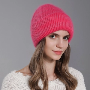 Women's bright pink winter knit beanie with soft rabbit fur texture and ribbed cuff