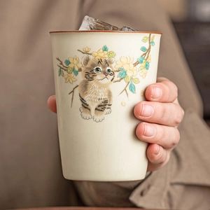 Handheld Ru ware ceramic tea cup with cute cat and flower patterns and ice cubes inside