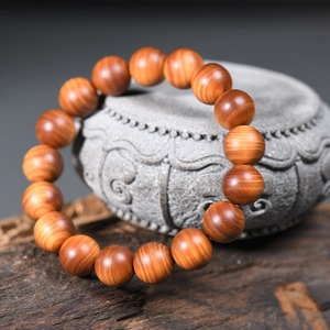 Aged cypress wood prayer beads with natural oily texture and high-gloss wood grain