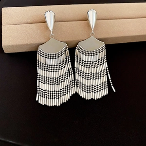 Detailed view of silver-tone tassel earrings with delicate metal beads and fan-shaped accents