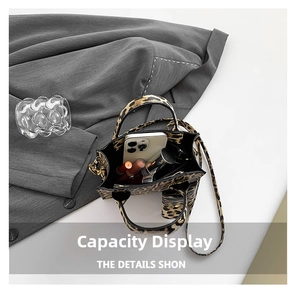 Interior view of small leopard print handbag showing space for phone and lipsticks