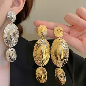 Exaggerated metal oval drop earrings with hammered texture and three-segment design