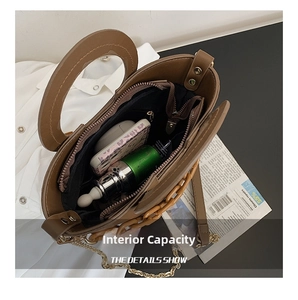 Interior detail of a brown leather bucket bag showing capacity for phone and cosmetics