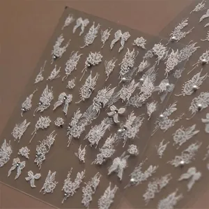 White lace 3D nail stickers with floral butterfly motifs, pearls and sparkling rhinestones