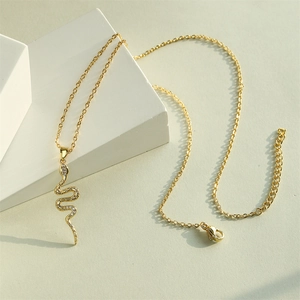 Elegant 18K gold-plated snake pendant necklace with shimmering zircon stones on a white base