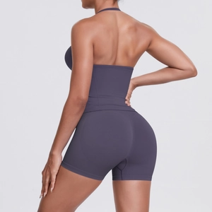 Detail view of seamless dark purple yoga set with halter sports top and high-waist shorts