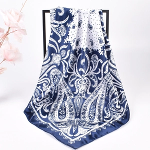 Detailed drape of navy and white paisley satin square scarf with elegant dot patterns
