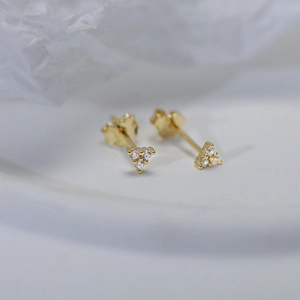 Detailed view of 925 silver gold-plated stud earrings with three-diamond triangle design