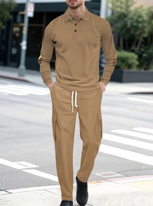 Detail of men's khaki waffle knit polo and drawstring pants set in a street style view