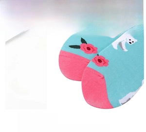 Detail of blue cotton socks with polar bear and red rose pattern with pink toe accents