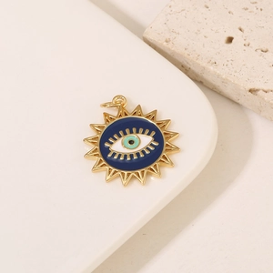 Detailed view of a 14K gold-plated sunburst evil eye pendant with blue enamel