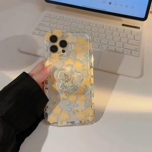 Detail of floral iPhone case with glitter flower stand and Jasmine lettering on a desk