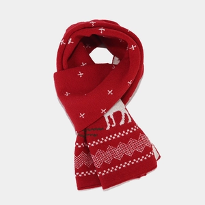 Detailed knit texture of red Christmas scarf featuring reindeer and white snowflake motifs
