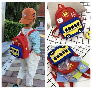 Toddler red bus backpack detail showing interior storage capacity and outdoor usage