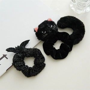 Detail of plush cat hair tie and glitter bat wing scrunchie set for Halloween accessories