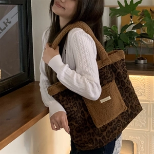 Detail of leopard print tote bag with plush pockets and stylish fuzzy texture handles
